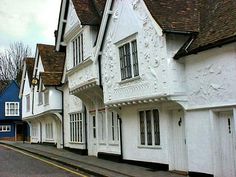 several white houses line the street in front of each other