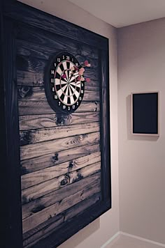 a dart in the center of a wooden wall with two pictures on either side of it