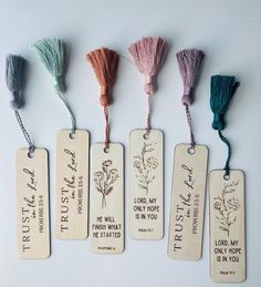 five tags with different types of tassels on them