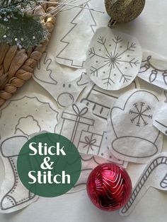 a table topped with christmas ornaments and paper cut out to look like snowflakes