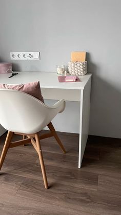 a white desk with a chair next to it on top of a hard wood floor