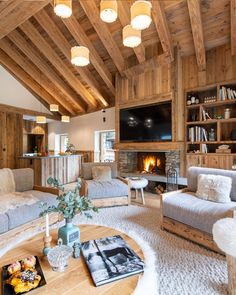 a living room filled with furniture and a fire place in the middle of a room