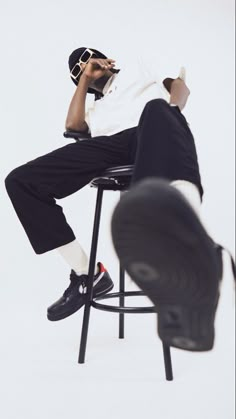 a man sitting on top of a black chair