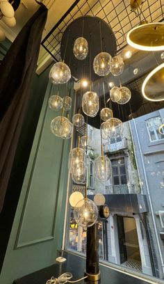 a chandelier hanging from the ceiling in a room with many lights on it