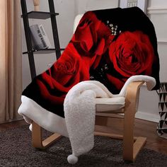 a chair covered in a blanket with red roses on it and a white teddy bear