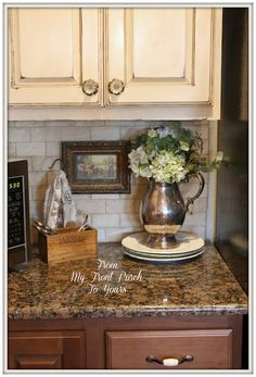 a kitchen counter with flowers in a vase on it