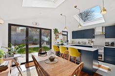 an open kitchen and dining room with skylights