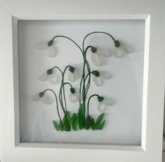 a white frame with some flowers in it