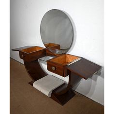 a wooden vanity with mirror and stool on carpeted floor