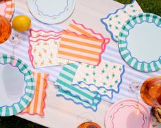 plates and napkins laid out on a picnic table