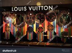 louis vutton store window display with colorful lights and decorations on the front glass windows