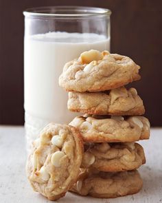 a stack of cookies next to a glass of milk