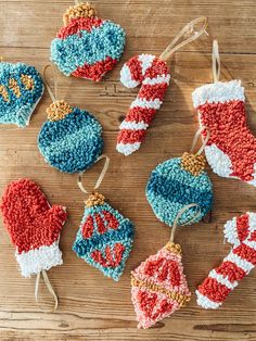 crocheted christmas ornaments are displayed on a wooden table