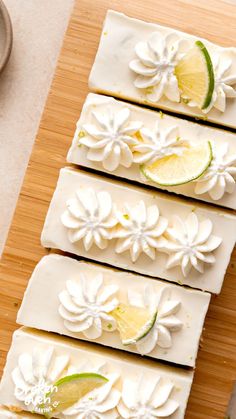 four slices of cake sitting on top of a wooden cutting board