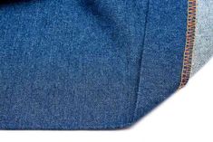 the back side of a pair of blue jeans with an orange stitching on it