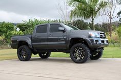 a gray truck parked on top of a driveway