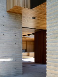 the inside of a building with wooden walls and floor to ceiling wood slats on the wall