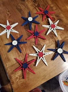 six red, white and blue stars are on a wooden table