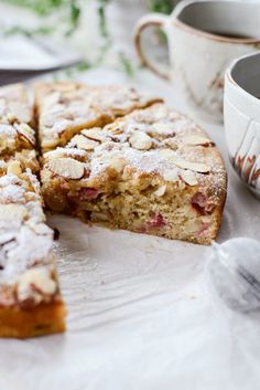 a piece of cake on a plate next to a cup