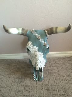 a cow skull with long horns and lace on it