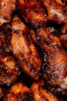 close up view of chicken wings with sauce on them