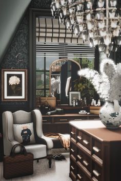 a living room filled with furniture and a chandelier hanging over the top of it