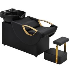 a black and gold reclining chair next to a foot stool with a sink in it