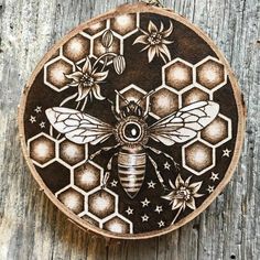 an image of a bee on a piece of wood with flowers and bees painted on it