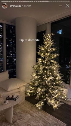 a living room with a christmas tree in the corner and lights on it's windows