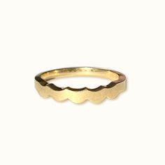 a gold ring with scalloped edges