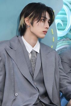 a man in a suit and tie sitting down