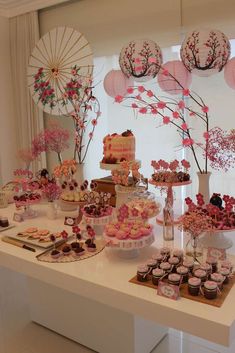 a table filled with lots of desserts and cupcakes on top of it