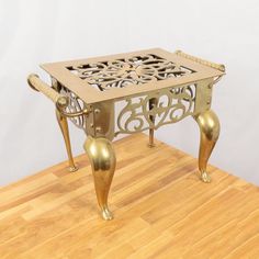 an ornately designed table sits on a wooden floor