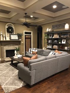 a living room filled with furniture and a fire place in the middle of the room