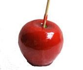 an apple with a wooden stick sticking out of it's center, on a white background