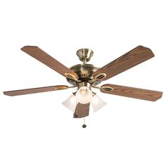 a ceiling fan with three wooden blades and two light bulbs on the top of it