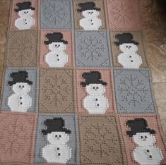 a crocheted blanket with snowmen on it