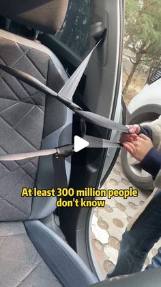 a person holding a large pair of scissors in the back seat of a car with text overlay that reads at least 300 million people don't know