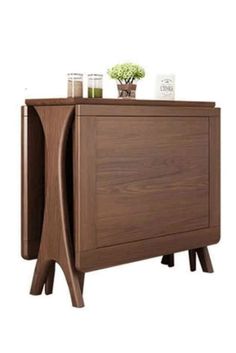 the sideboard is made from wood and has two drawers, one with a plant on top