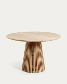 a round wooden table sitting on top of a white floor