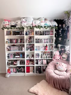 a living room filled with lots of books and stuffed animals on the wall next to it