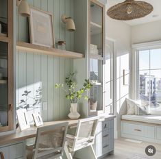 a room that has some shelves and chairs in it with plants on the table next to them