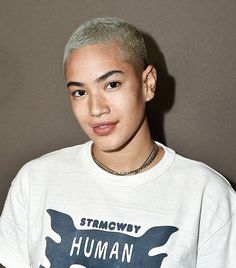 a young man with grey hair wearing a t - shirt that says, strongwoy human rights