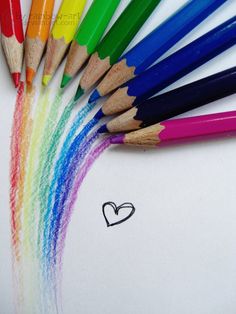 several colored pencils are lined up next to each other with a heart drawn on them