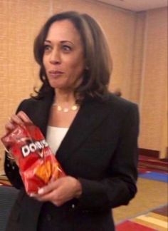 a woman holding a bag of chips in her hand