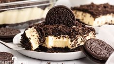 an oreo cookie cheesecake on a white plate with two oreos in the background