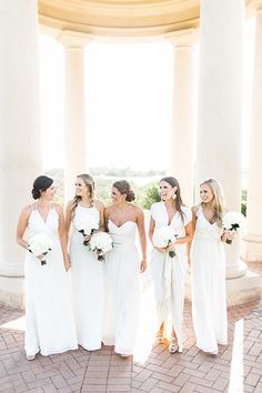 a group of women standing next to each other in front of pillars with their names on them