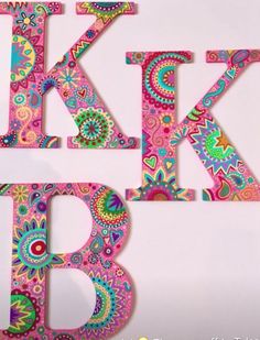 the letter k is made up of colorful paisley patterns and letters are cut out of paper