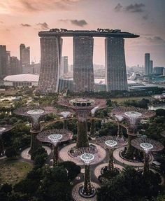 an aerial view of gardens by the bay in singapore, with skyscrapers in the background