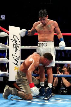 two men standing next to each other in a boxing ring